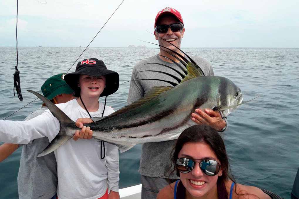 A family half day fishing trip with their trophy catch a roosterfish.