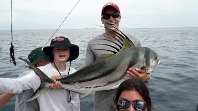 A family half day fishing trip with their trophy catch a roosterfish.